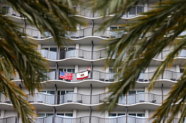 Guests at the Anaheim Marriott Hotel hang flags on their balcony during the California