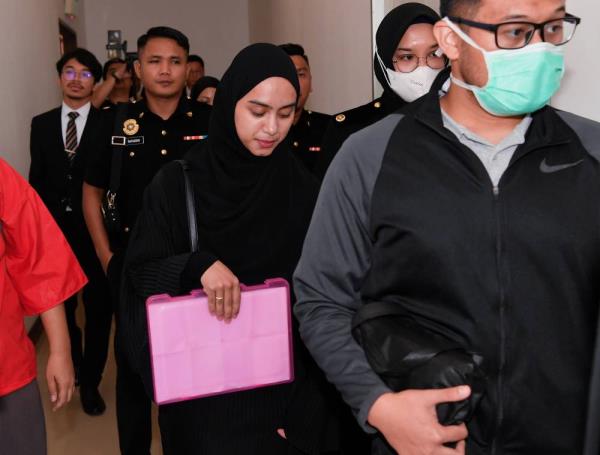 Social media influencer Aisyah Hijanah Azhari, 26, pleaded not guilty to 10 charges of misappropriation of funds collected for charitable activities amounting to more than RM1.52 million. - Photo by Bernama